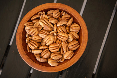 wooden bowl of shelled elliot pecans