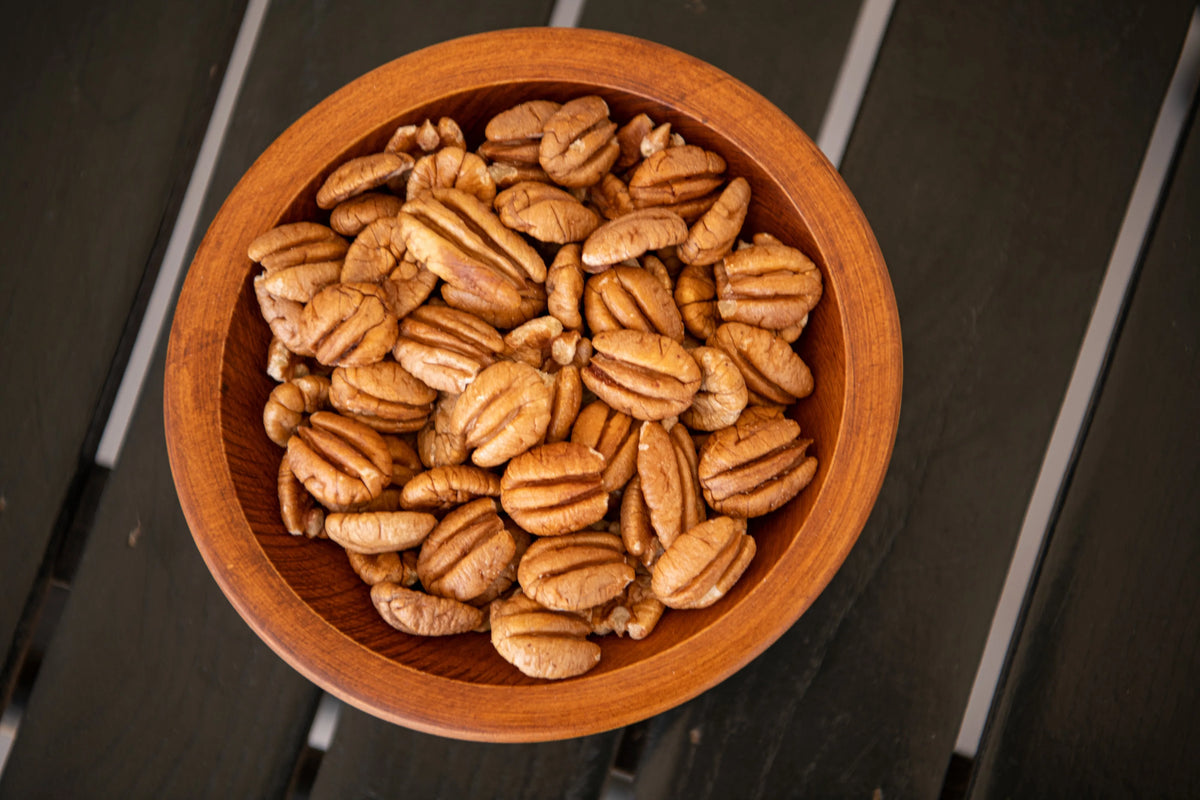 wooden bowl of shelled elliot pecans