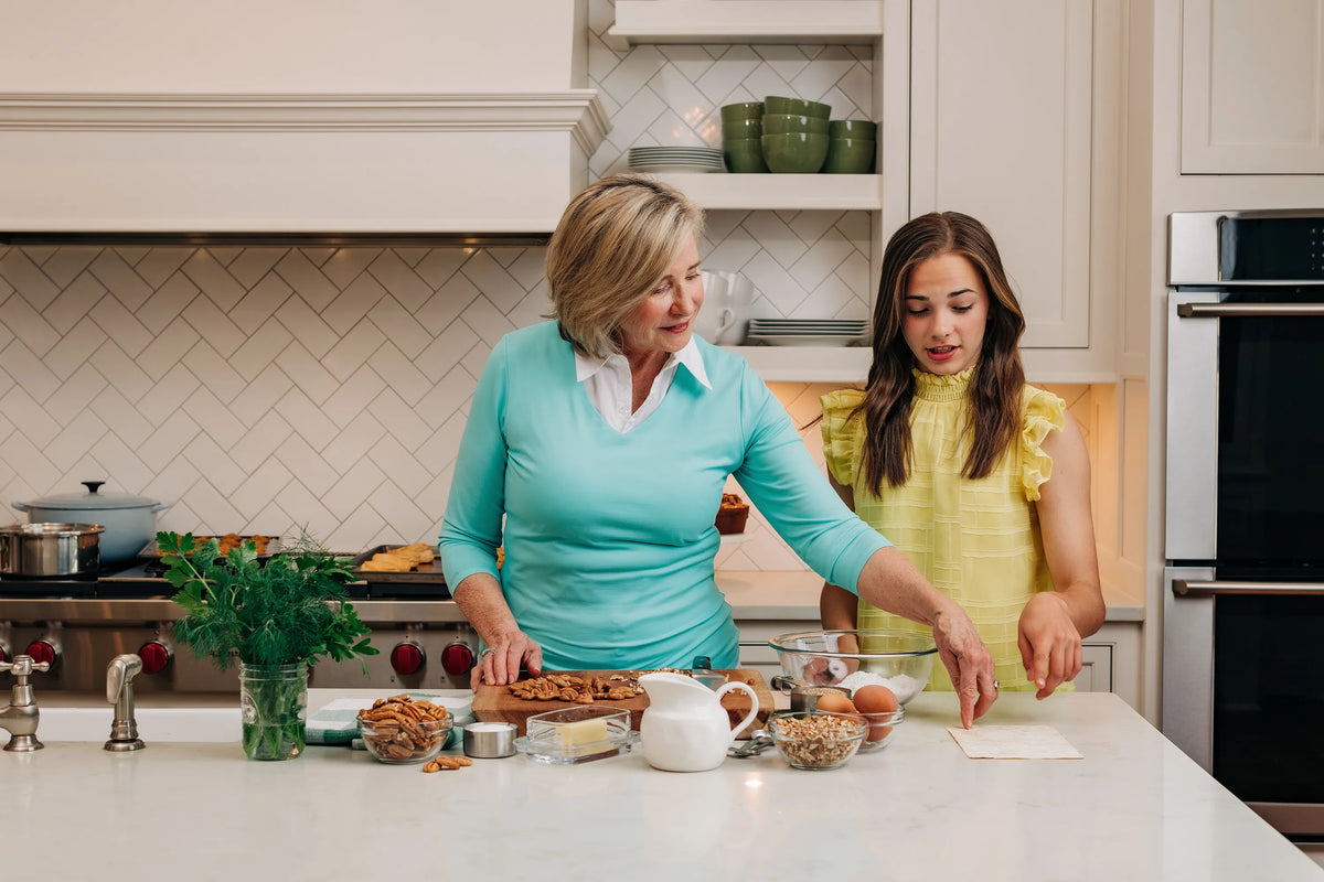 Mary and Adeline Pearson baking in the kitchen 